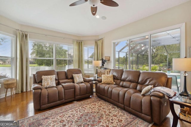 living room with hardwood / wood-style flooring, a wealth of natural light, and ceiling fan