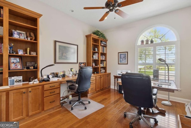 office with ceiling fan and light hardwood / wood-style flooring