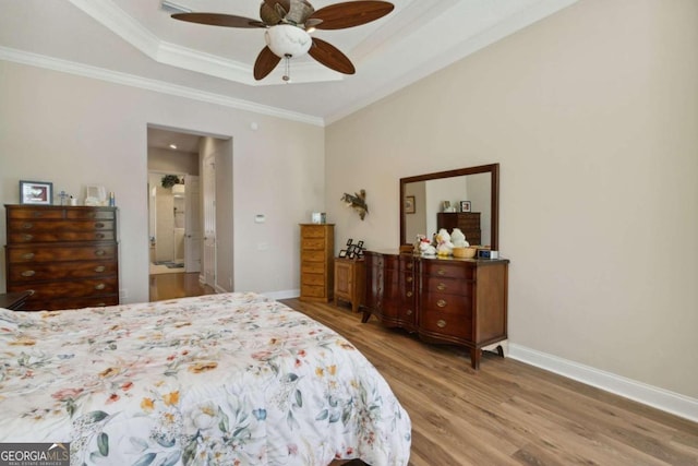 2491 Isles Of St Marys Way, Saint Marys, GA 31558 - bedroom with baseboards, wood finished floors, a raised ceiling, ornamental molding, and ceiling fan