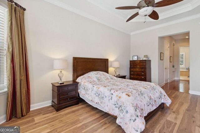 bedroom featuring crown molding, multiple windows, light wood-type flooring, and ceiling fan