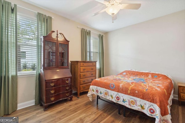 bedroom with hardwood / wood-style flooring and ceiling fan