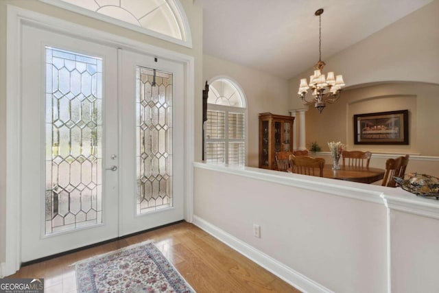 2491 Isles Of St Marys Way, Saint Marys, GA 31558 - entrance foyer featuring a chandelier, french doors, healthy amount of natural light, vaulted ceiling, and wood finished floors