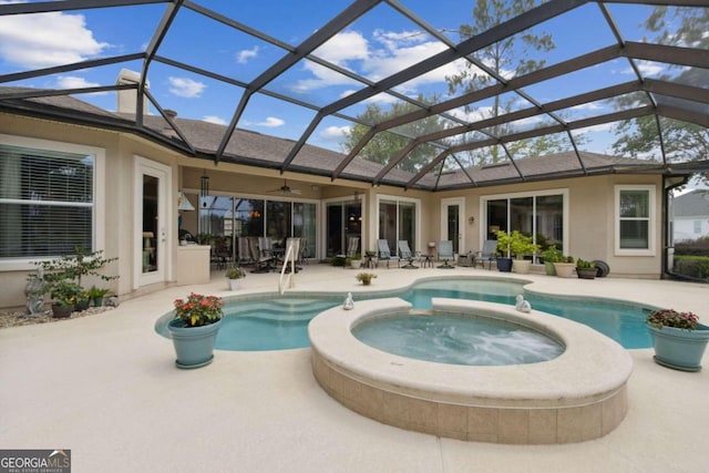 view of pool with an in ground hot tub, a patio, ceiling fan, and a lanai