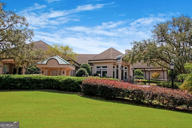 rear view of house featuring a lawn