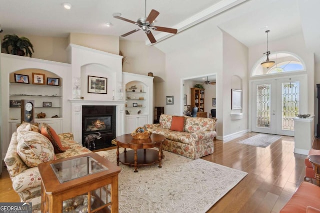 2491 Isles Of St Marys Way, Saint Marys, GA 31558 - living area with ceiling fan, high vaulted ceiling, a fireplace with flush hearth, wood finished floors, and french doors