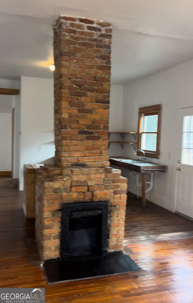 interior details with a fireplace and hardwood / wood-style flooring