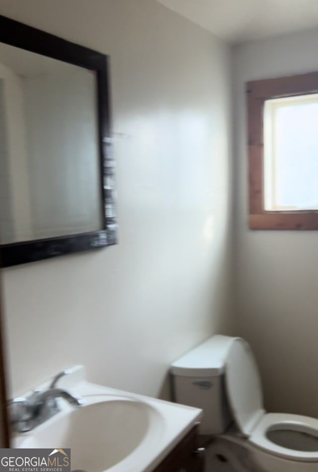 bathroom featuring toilet and vanity