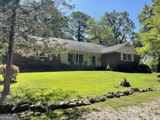 ranch-style home with a front lawn