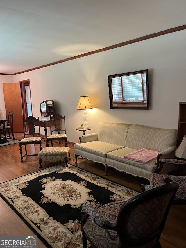 living room with ornamental molding, wood-type flooring, and plenty of natural light