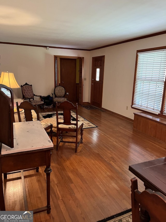 living room featuring wood-type flooring and ornamental molding