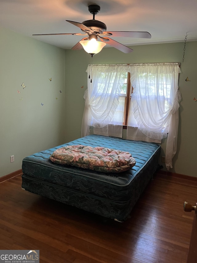 bedroom featuring dark hardwood / wood-style floors and ceiling fan