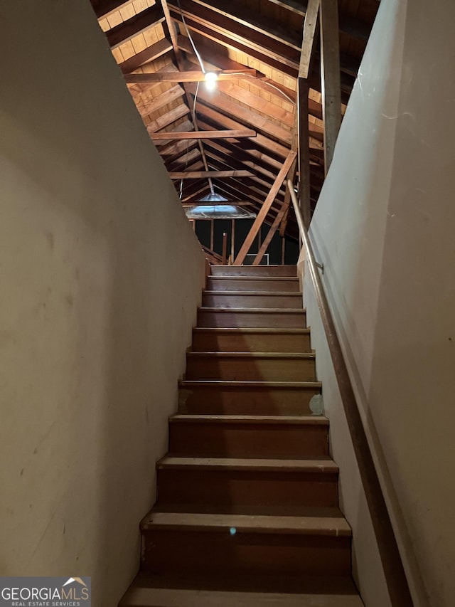 staircase with wood ceiling and lofted ceiling