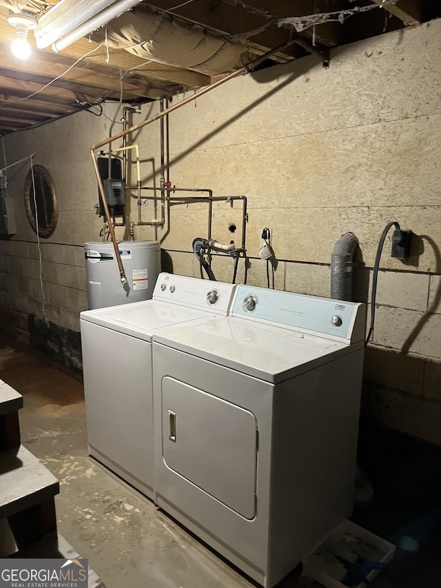 laundry room featuring electric water heater and washing machine and dryer