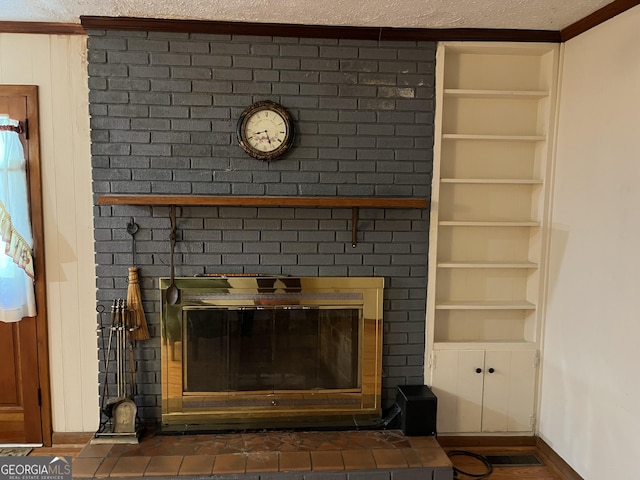 details featuring built in features, a brick fireplace, and a textured ceiling