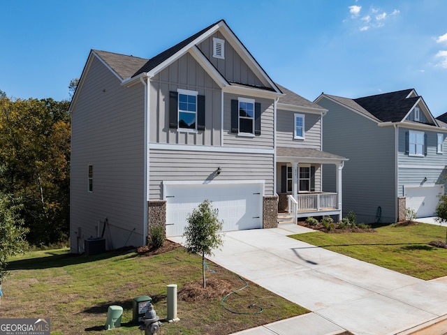 craftsman house featuring cooling unit, a front lawn, and a garage