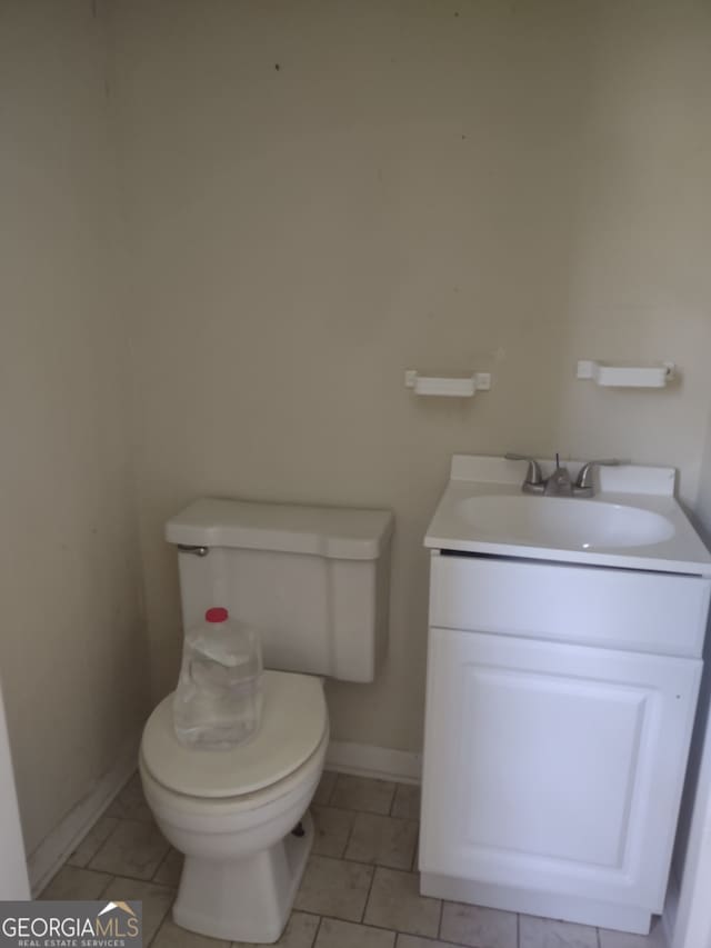 bathroom with tile patterned flooring, toilet, and vanity