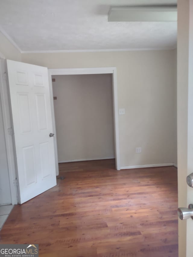 empty room with wood-type flooring