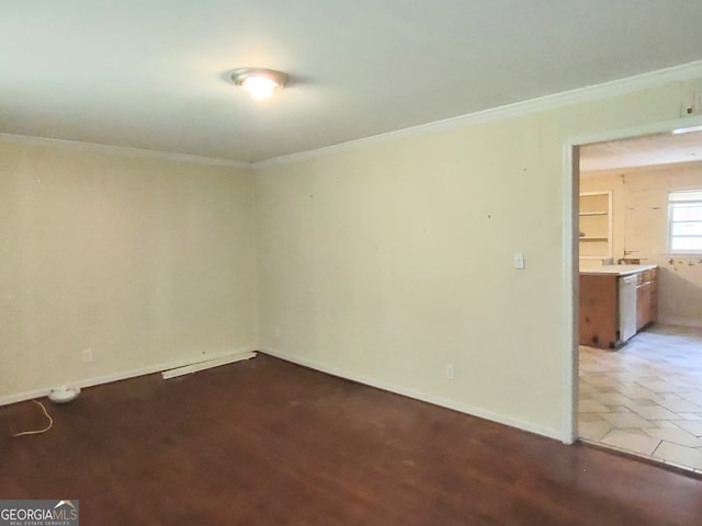 tiled spare room featuring ornamental molding