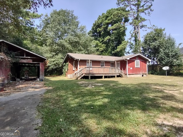 rear view of property with central AC unit, a deck, and a yard