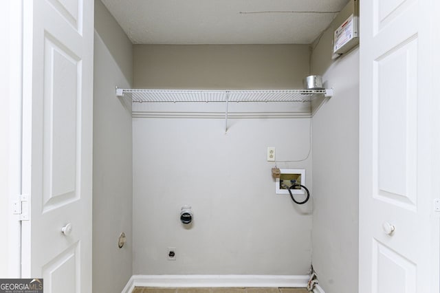 laundry room featuring electric dryer hookup, washer hookup, and light tile patterned floors