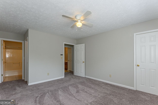 unfurnished bedroom featuring ceiling fan, light colored carpet, and a textured ceiling