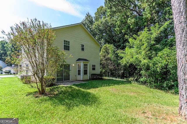 back of house with a lawn