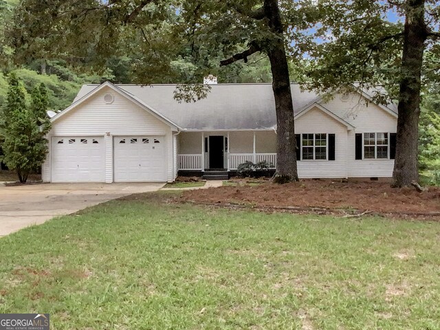 single story home featuring a porch, a garage, and a front lawn