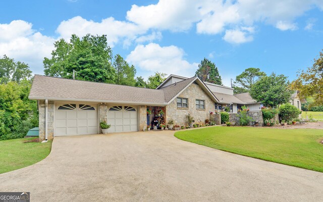 view of front of house with a garage and a front lawn