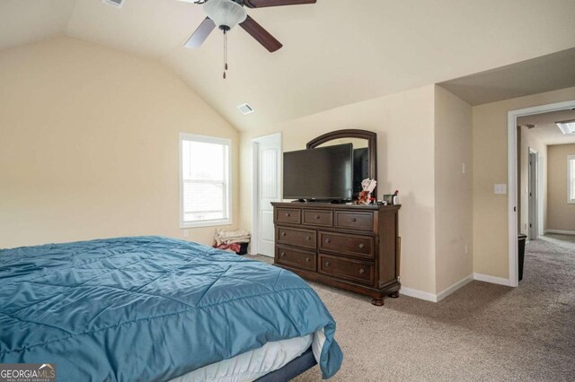 carpeted bedroom featuring ceiling fan and vaulted ceiling