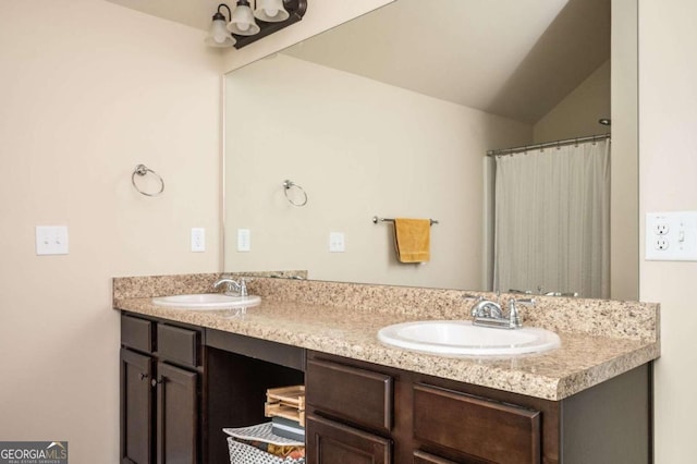 bathroom with vanity and vaulted ceiling