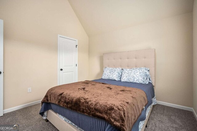 bedroom featuring lofted ceiling and carpet floors