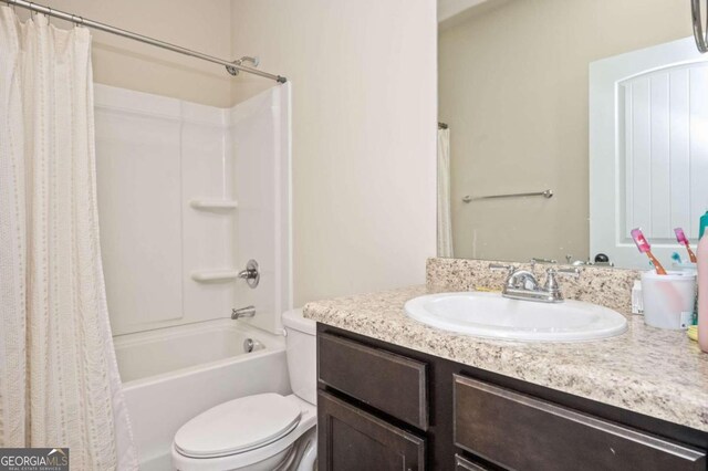 full bathroom featuring vanity, toilet, and shower / bath combination with curtain