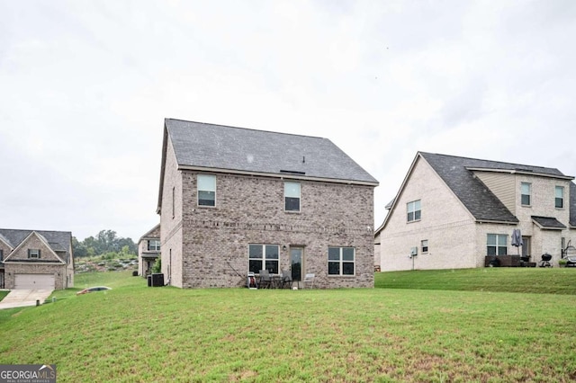 rear view of house with central AC and a lawn