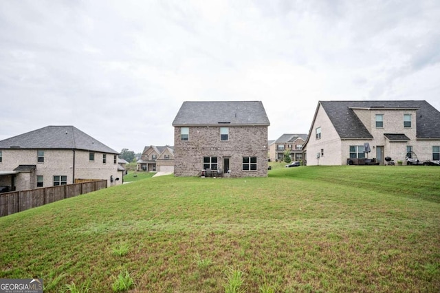 back of house featuring a lawn