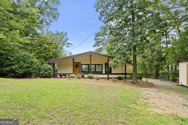 view of front of house with covered porch and a front lawn