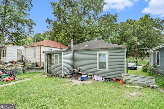 rear view of house with a yard