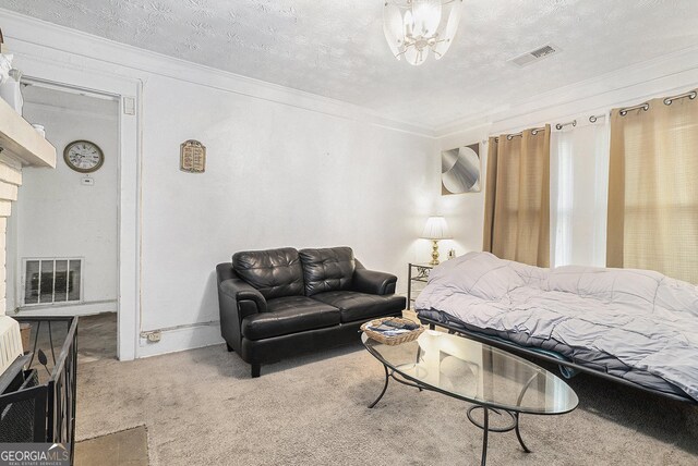 bedroom with ornamental molding, a textured ceiling, and carpet flooring