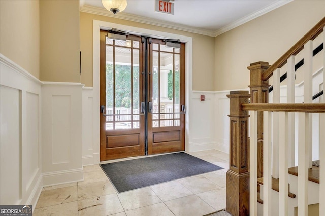 tiled entrance foyer featuring ornamental molding and french doors