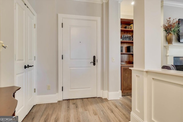 entrance foyer with crown molding and light wood-type flooring