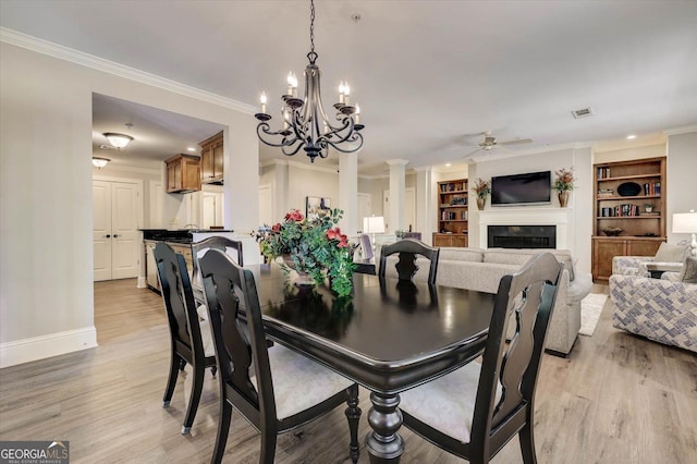 dining space featuring crown molding, built in features, light hardwood / wood-style flooring, and ceiling fan