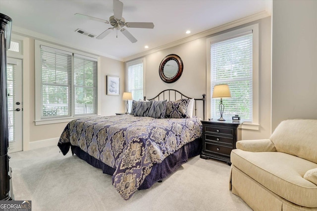 carpeted bedroom with ceiling fan and ornamental molding