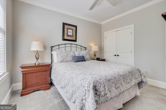 carpeted bedroom featuring a closet, ceiling fan, and ornamental molding