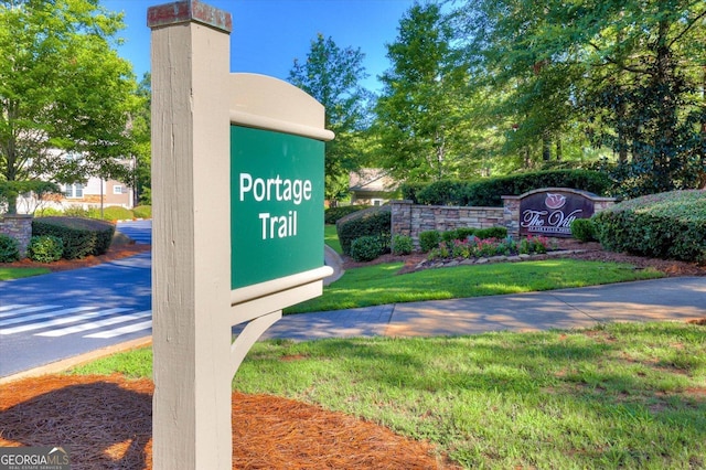 community sign featuring a lawn