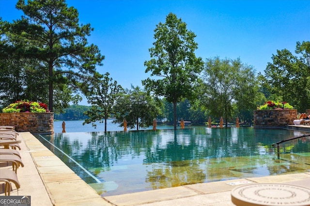 view of pool with a water view