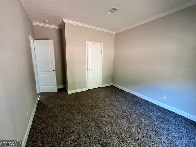 unfurnished bedroom featuring ornamental molding, dark colored carpet, and a textured ceiling