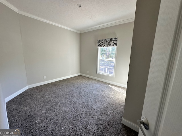 spare room featuring dark carpet, crown molding, and a textured ceiling