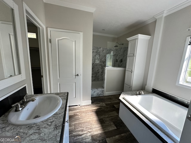 bathroom featuring vanity, crown molding, plus walk in shower, and wood-type flooring