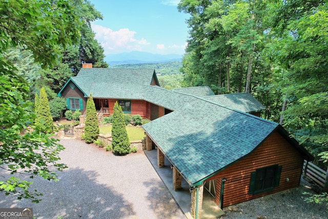 view of property exterior with a mountain view