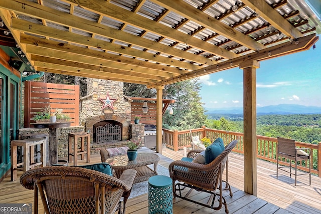 wooden terrace featuring a mountain view, an outdoor hangout area, and a pergola