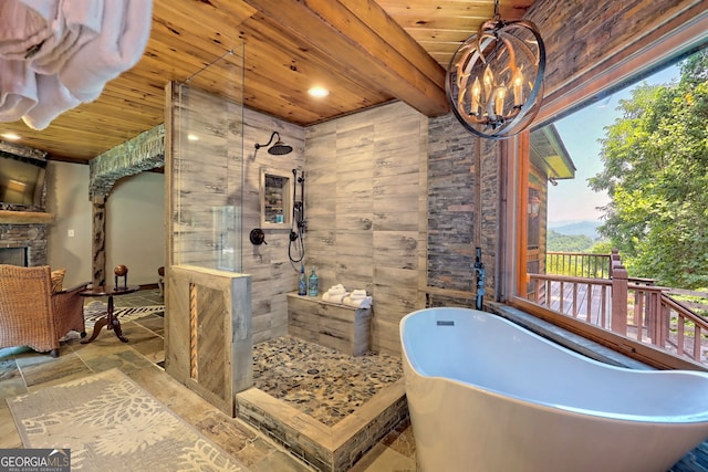 bathroom with plus walk in shower, a stone fireplace, plenty of natural light, and wooden ceiling